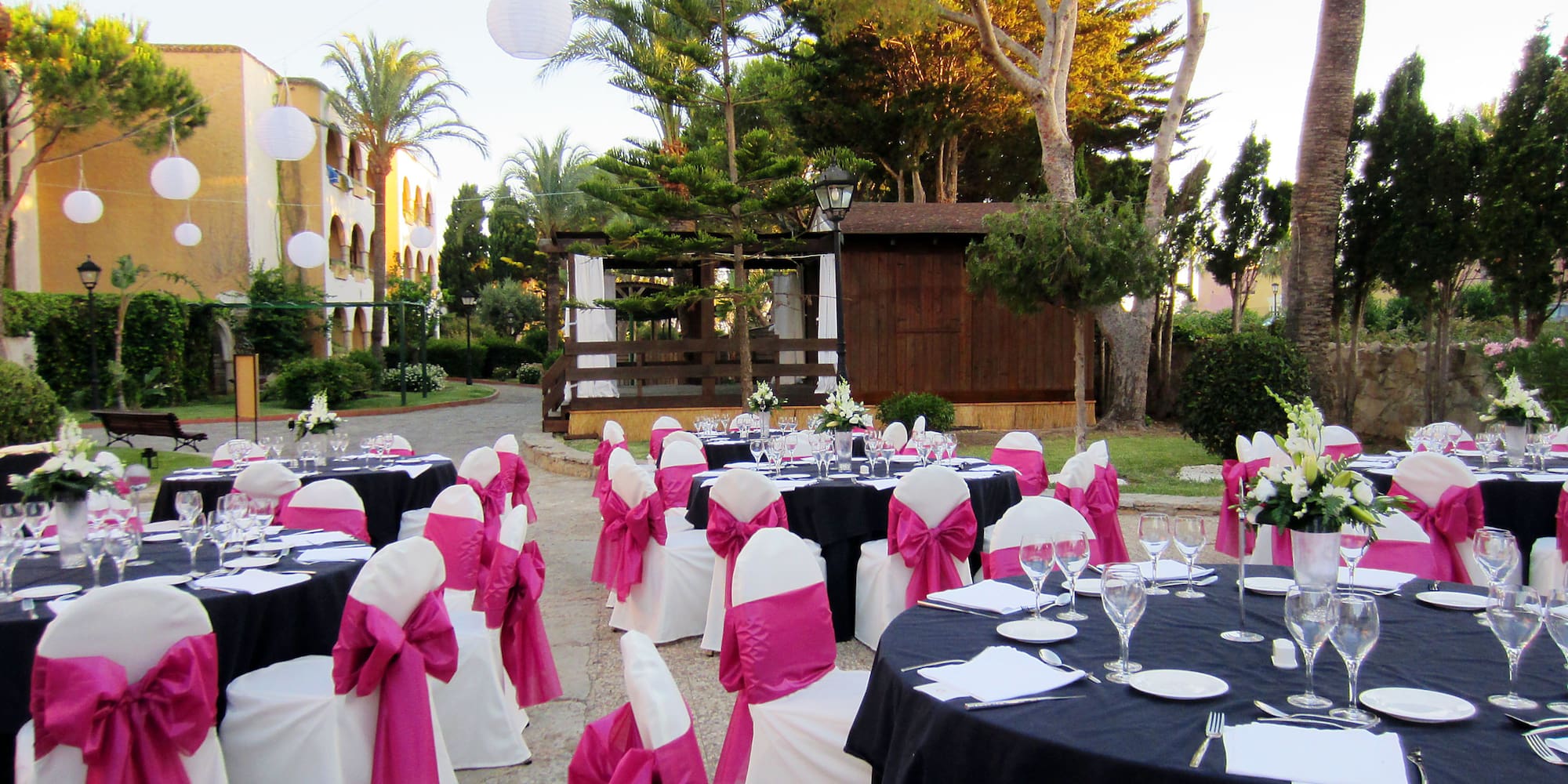 a set of tables with chairs and pink bows