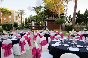a set of tables with chairs and pink bows