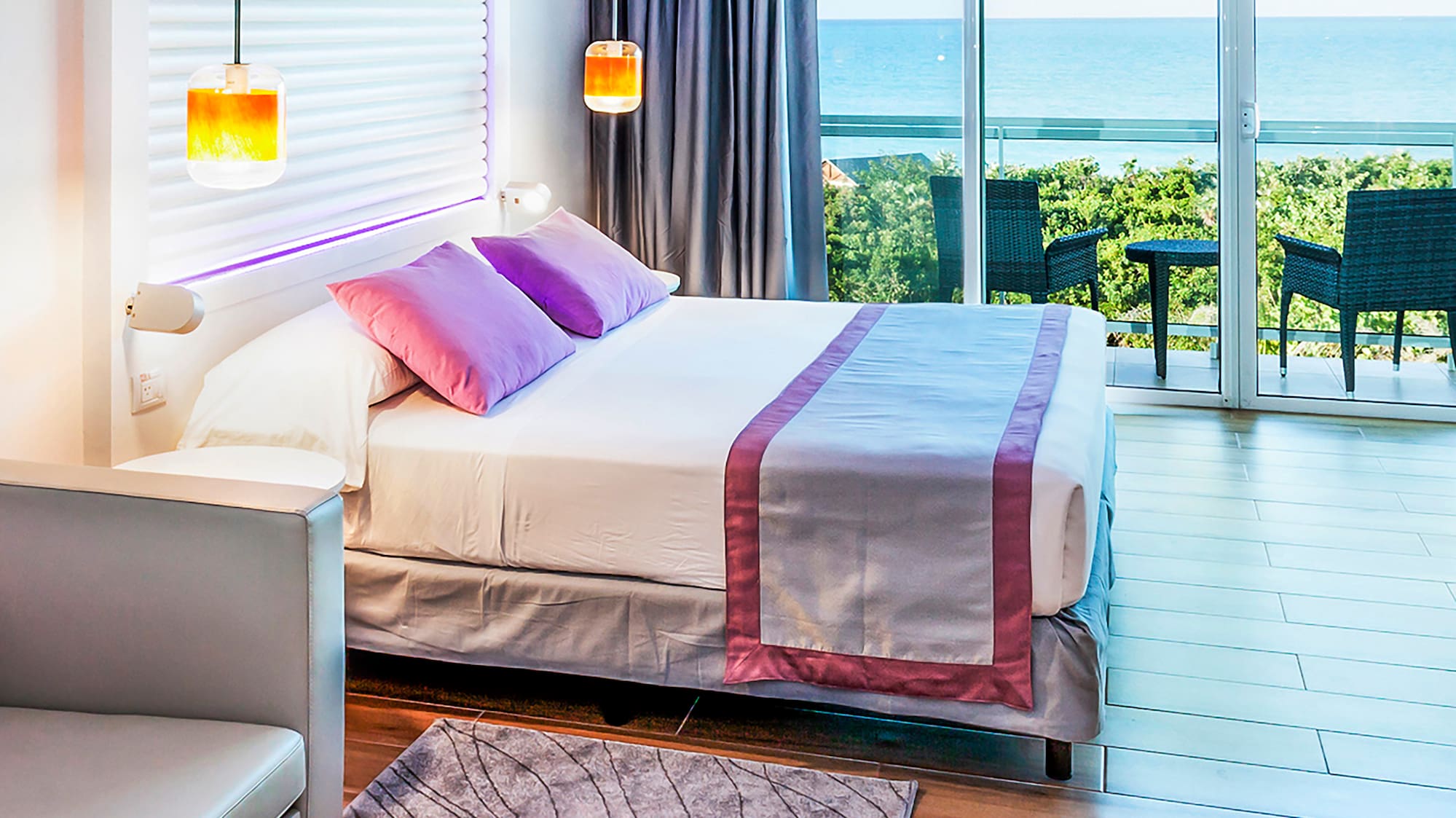 a bedroom with a bed and a table and chairs