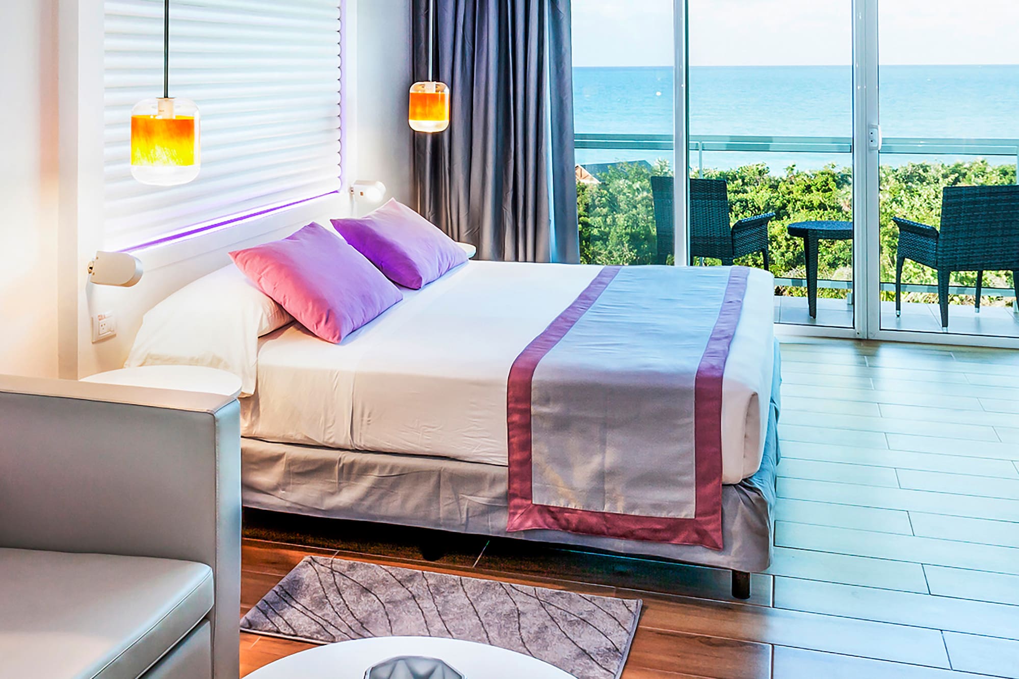 a bedroom with a bed and a table and chairs