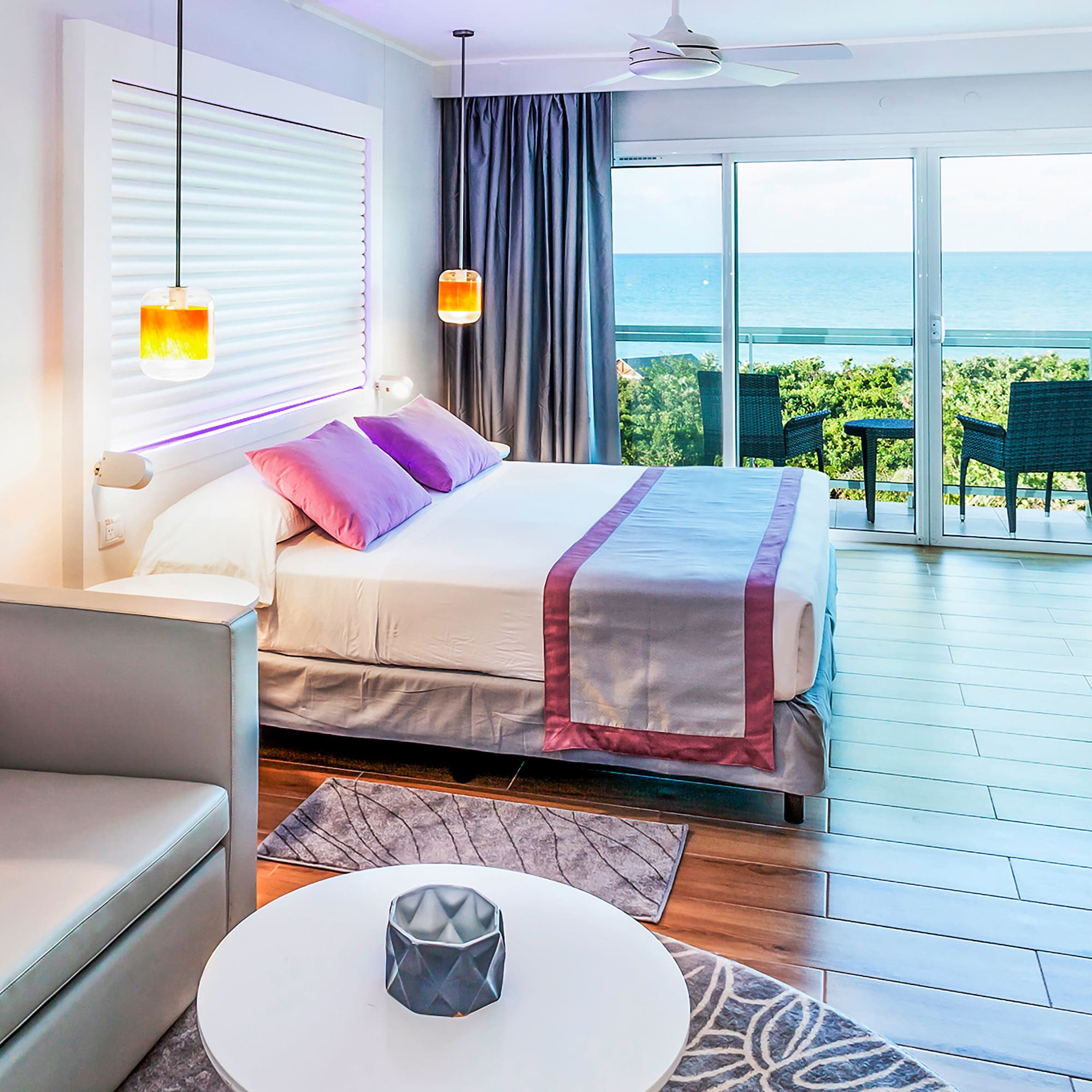 a bedroom with a bed and a table and chairs