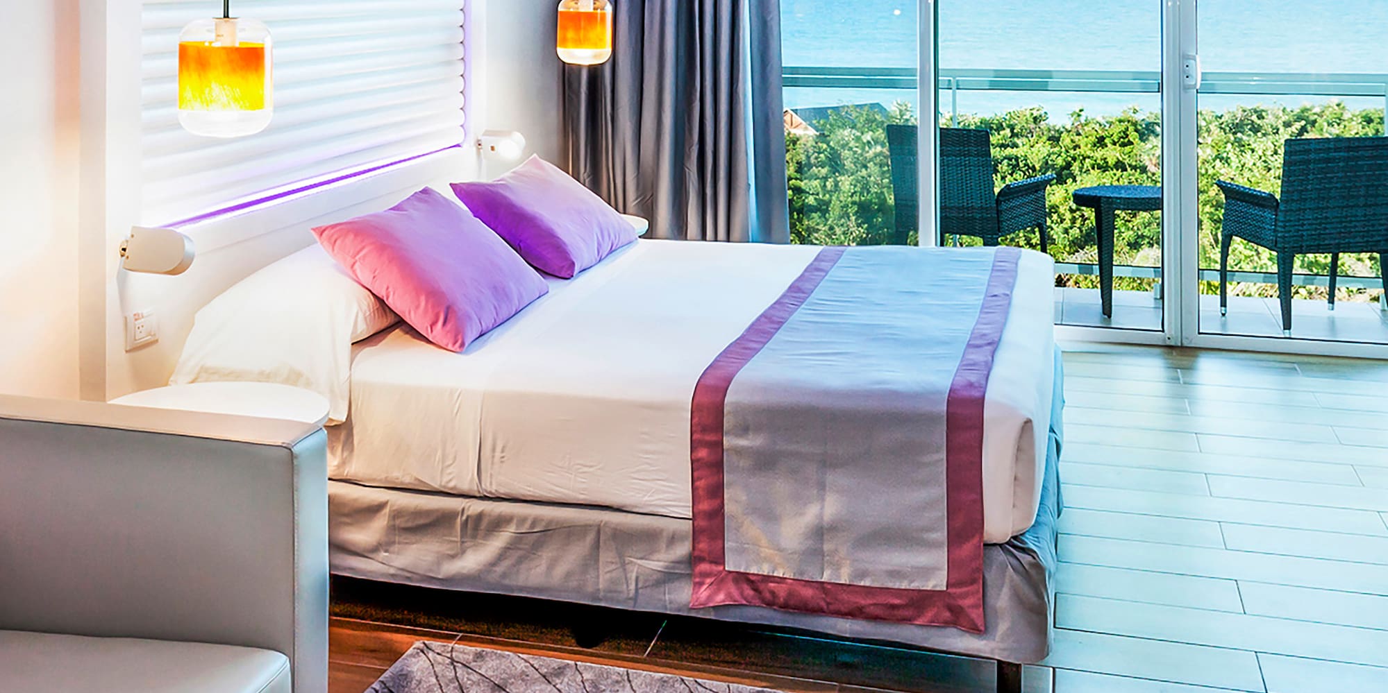 a bedroom with a bed and a table and chairs