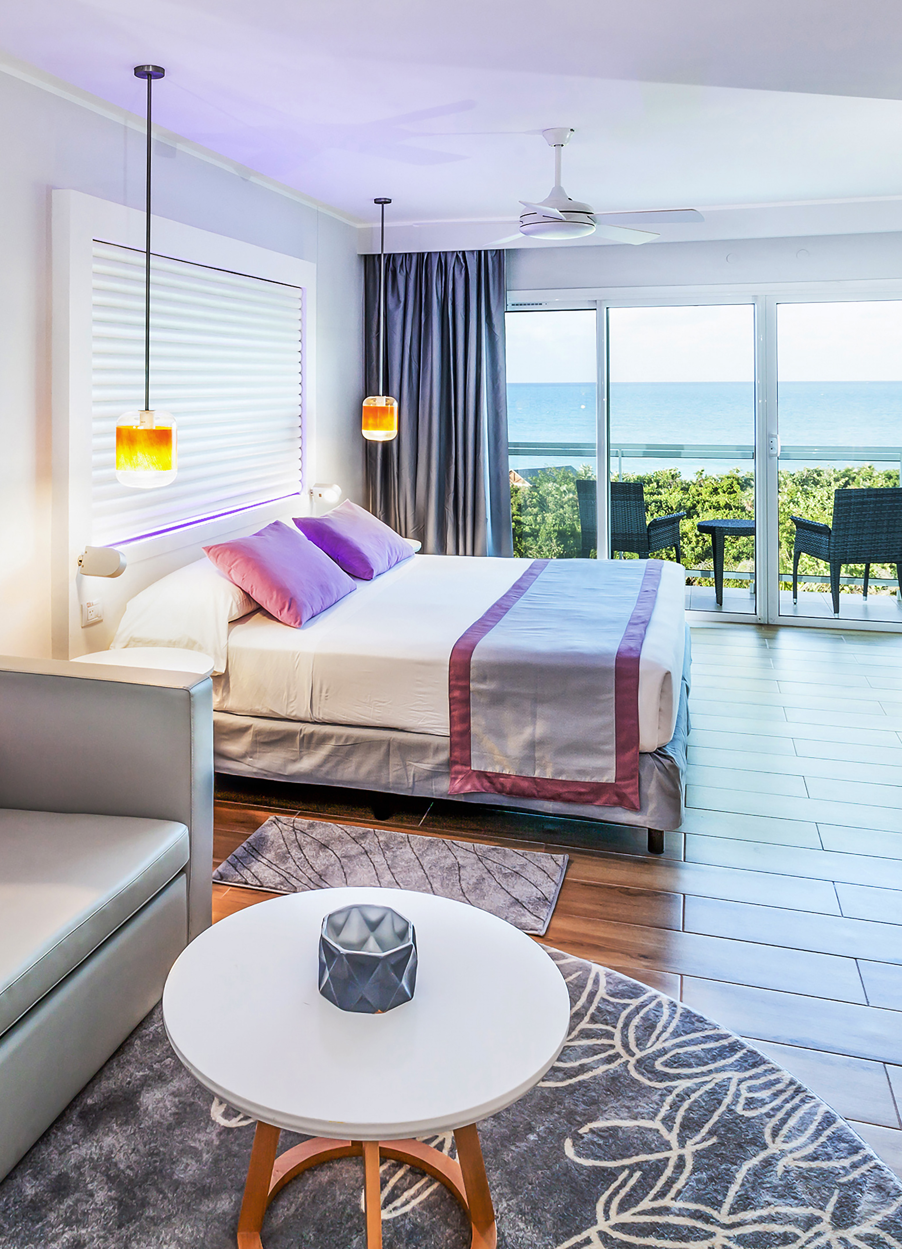 a bedroom with a bed and a table and chairs