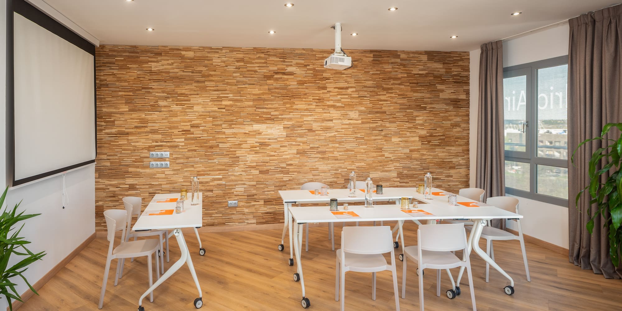 a room with white tables and chairs