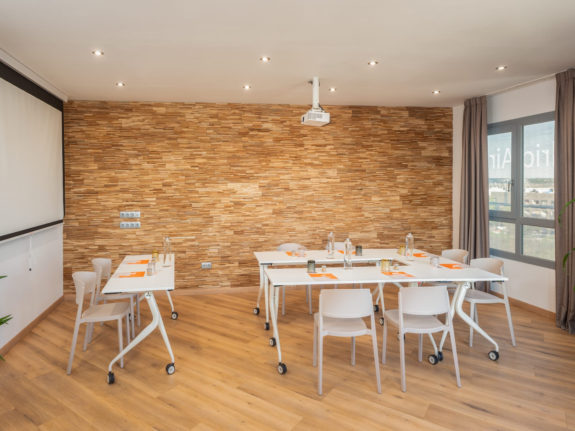 a room with white tables and chairs