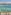 Hotel balcony with clear turquoise sea view, forested coast, and lounge chairs.