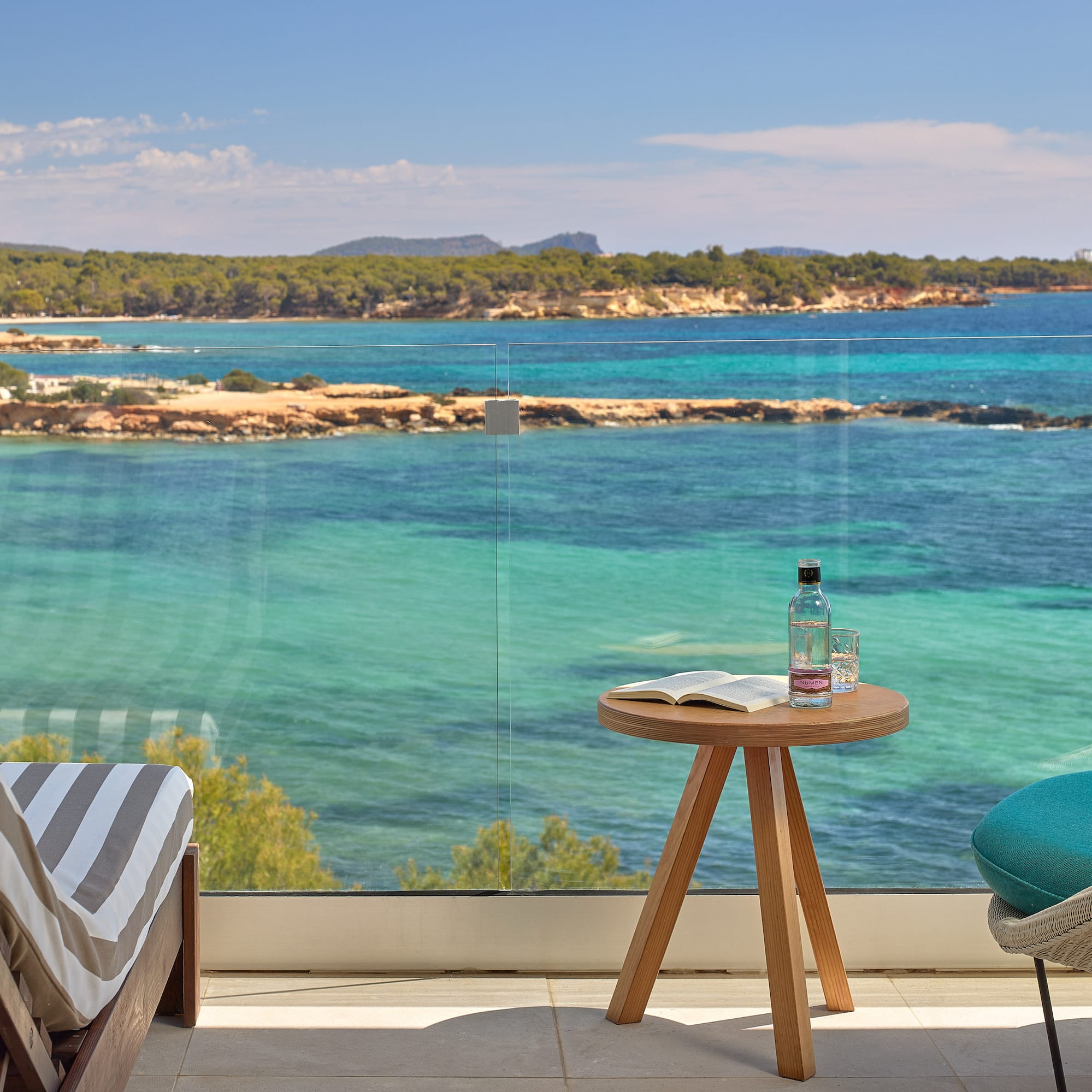 a table and chair with a view of the ocean