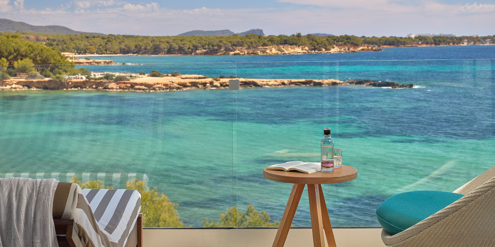 a table and chair with a view of the ocean