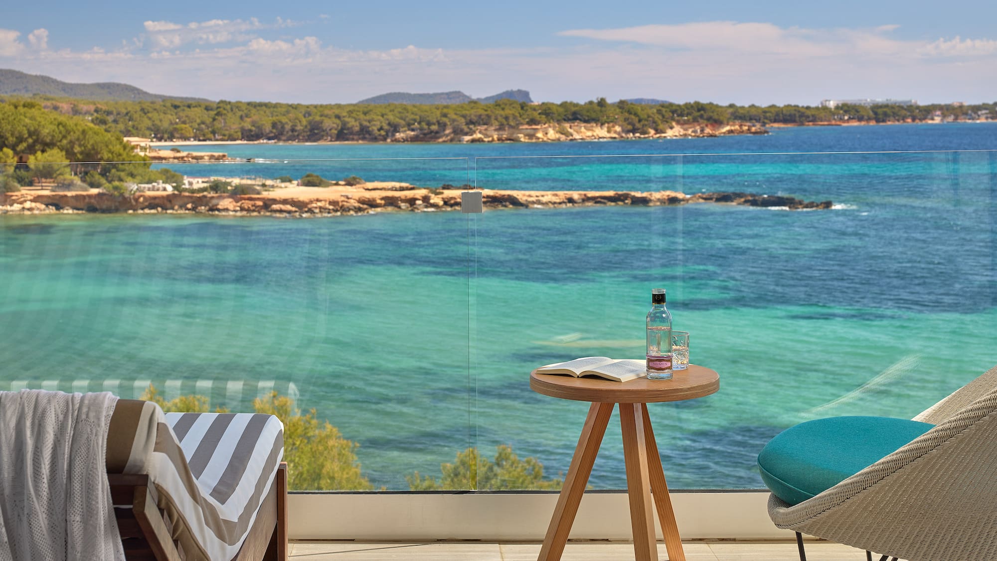a table and chair with a view of the ocean