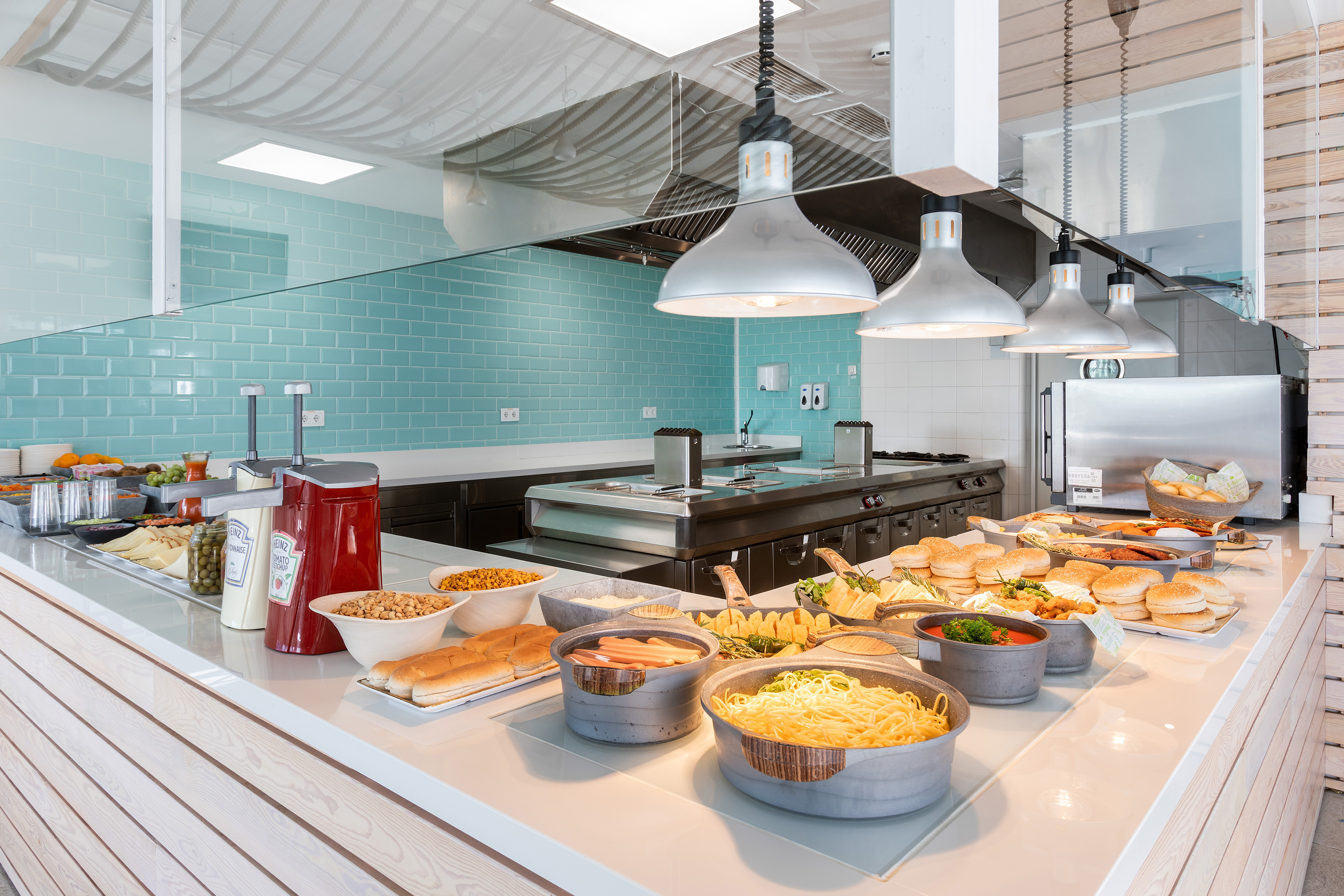 Bright, modern buffet counter featuring varied fresh food options.