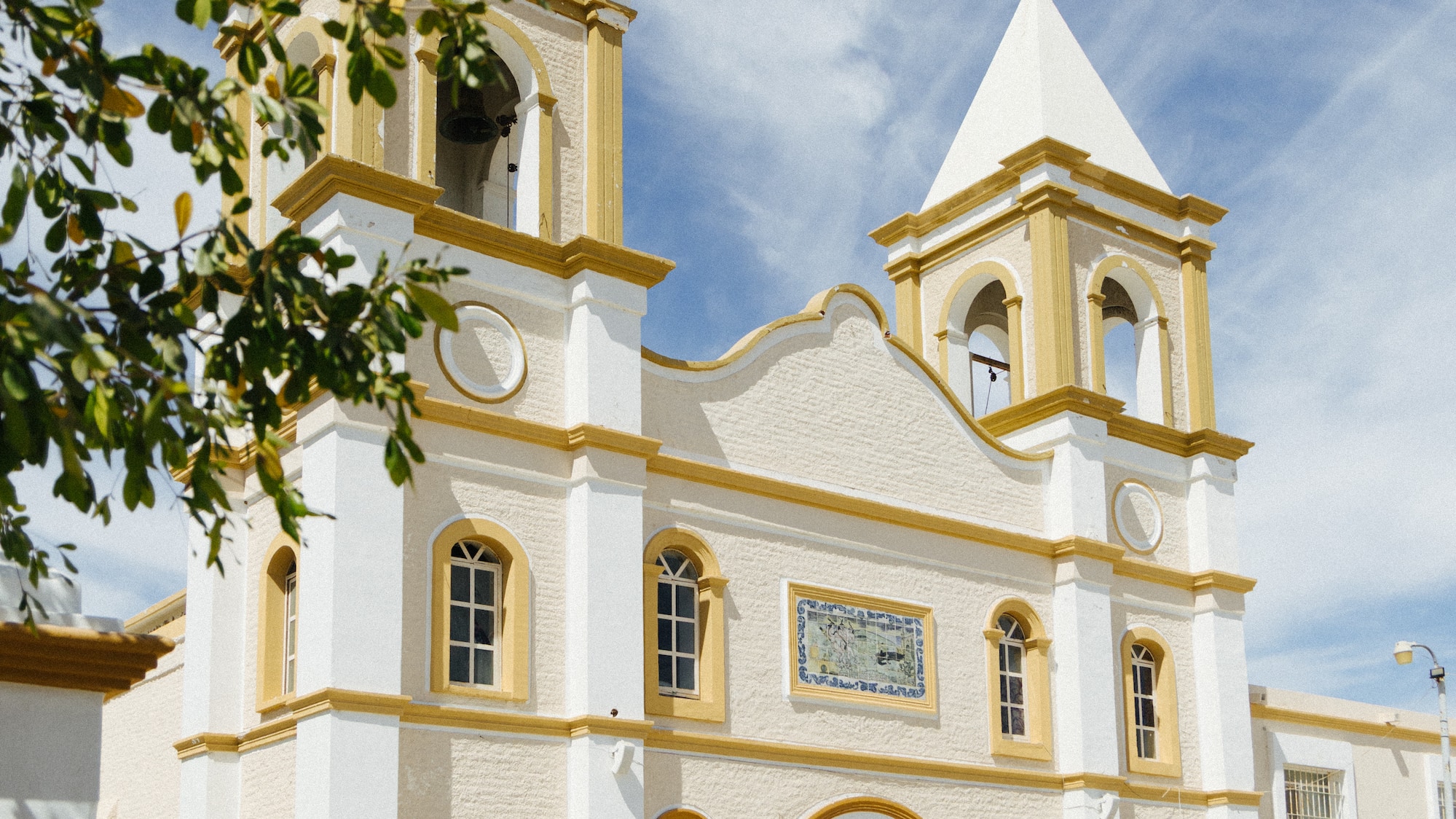 a white and yellow building with a steeple
