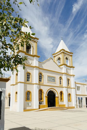 a white and yellow building with a steeple