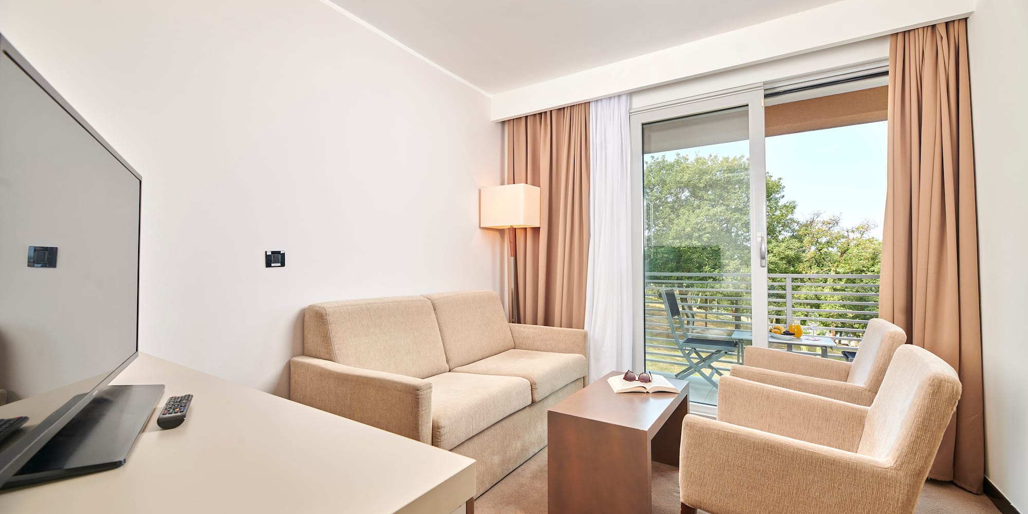 a room with a couch and chairs