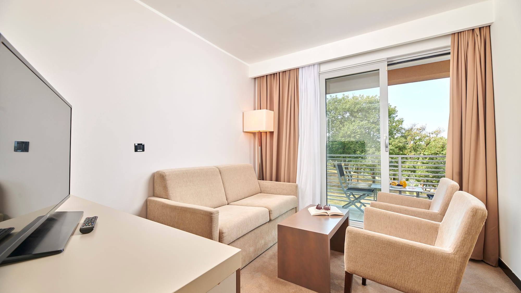 a room with a couch and chairs