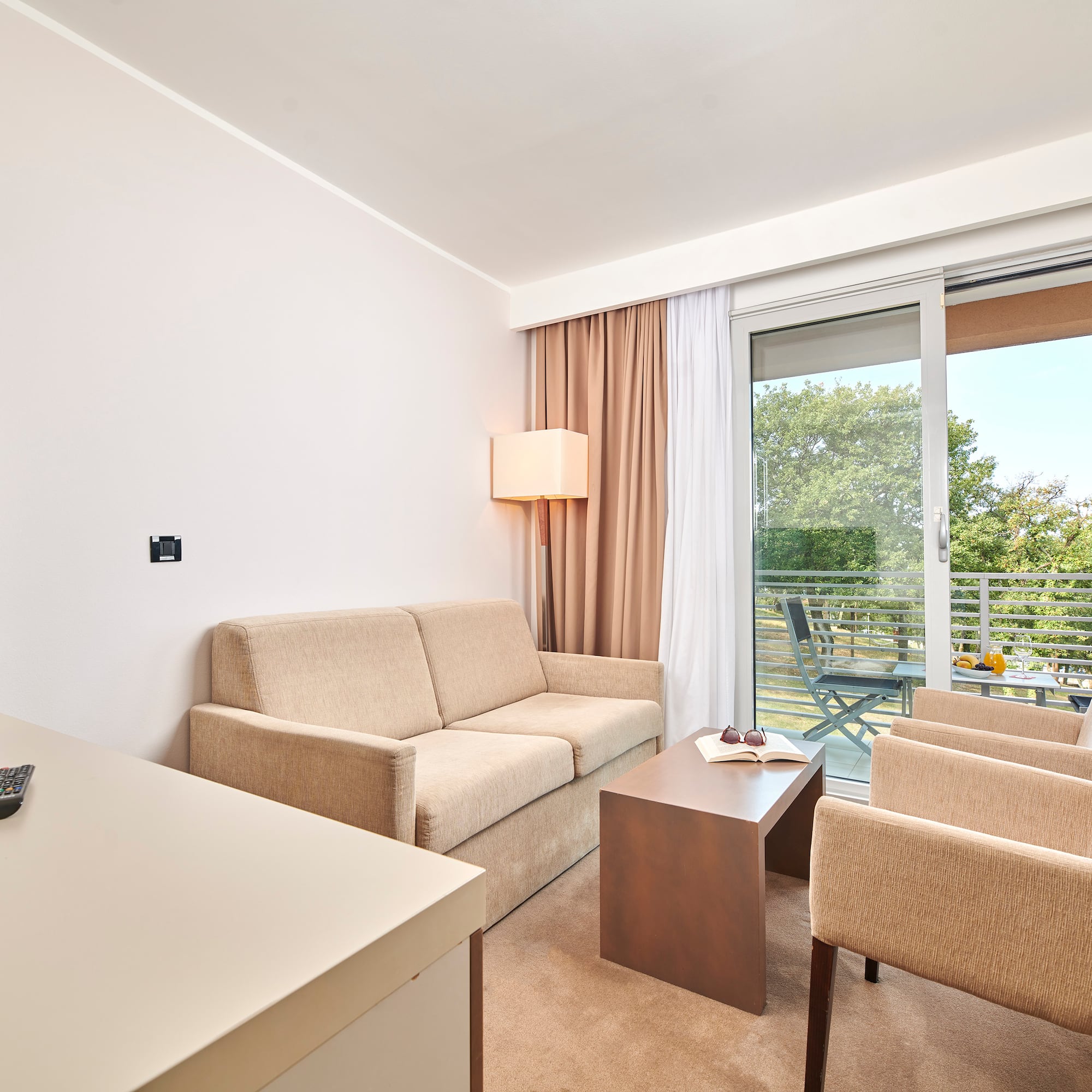 a room with a couch and chairs