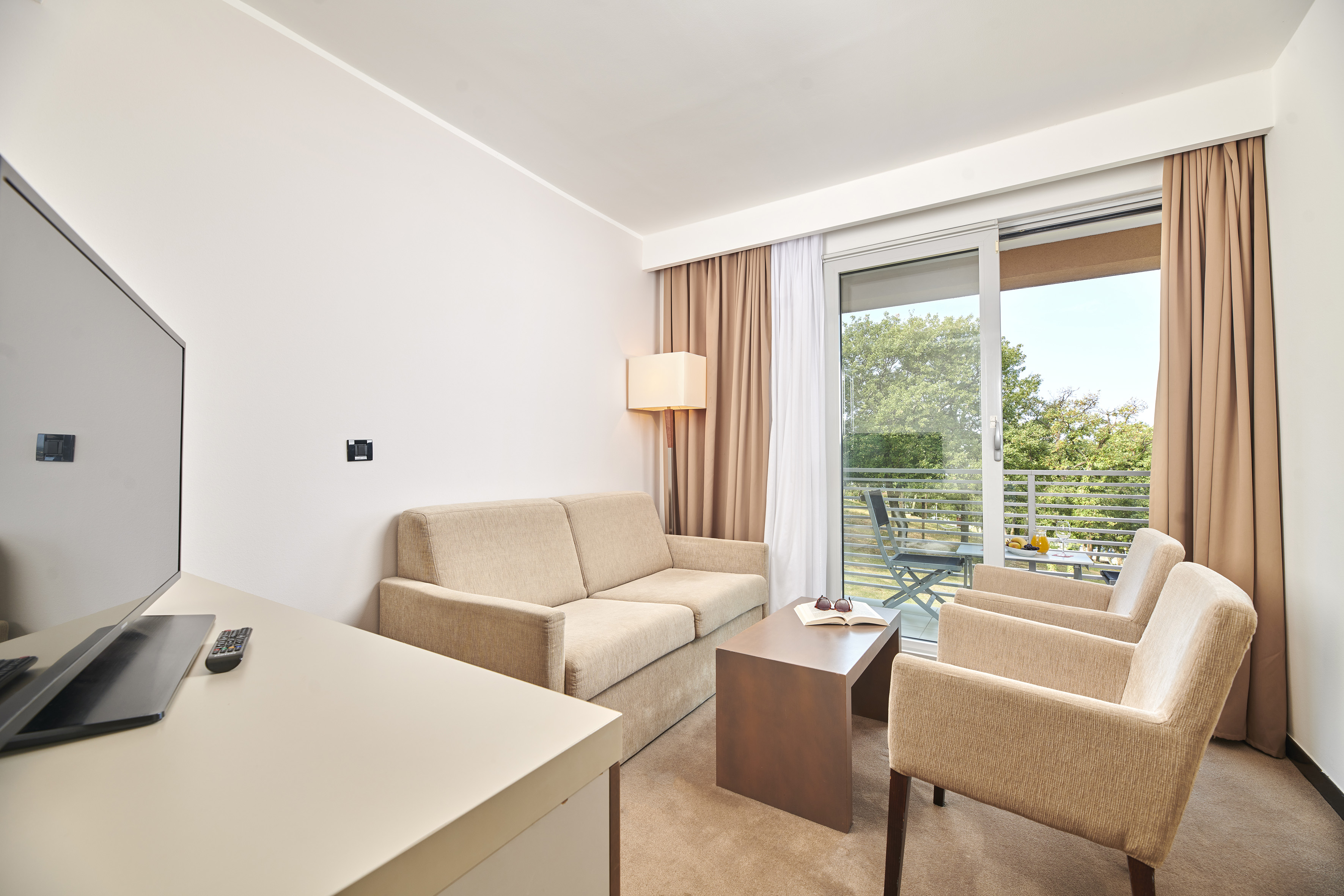 a room with a couch and chairs