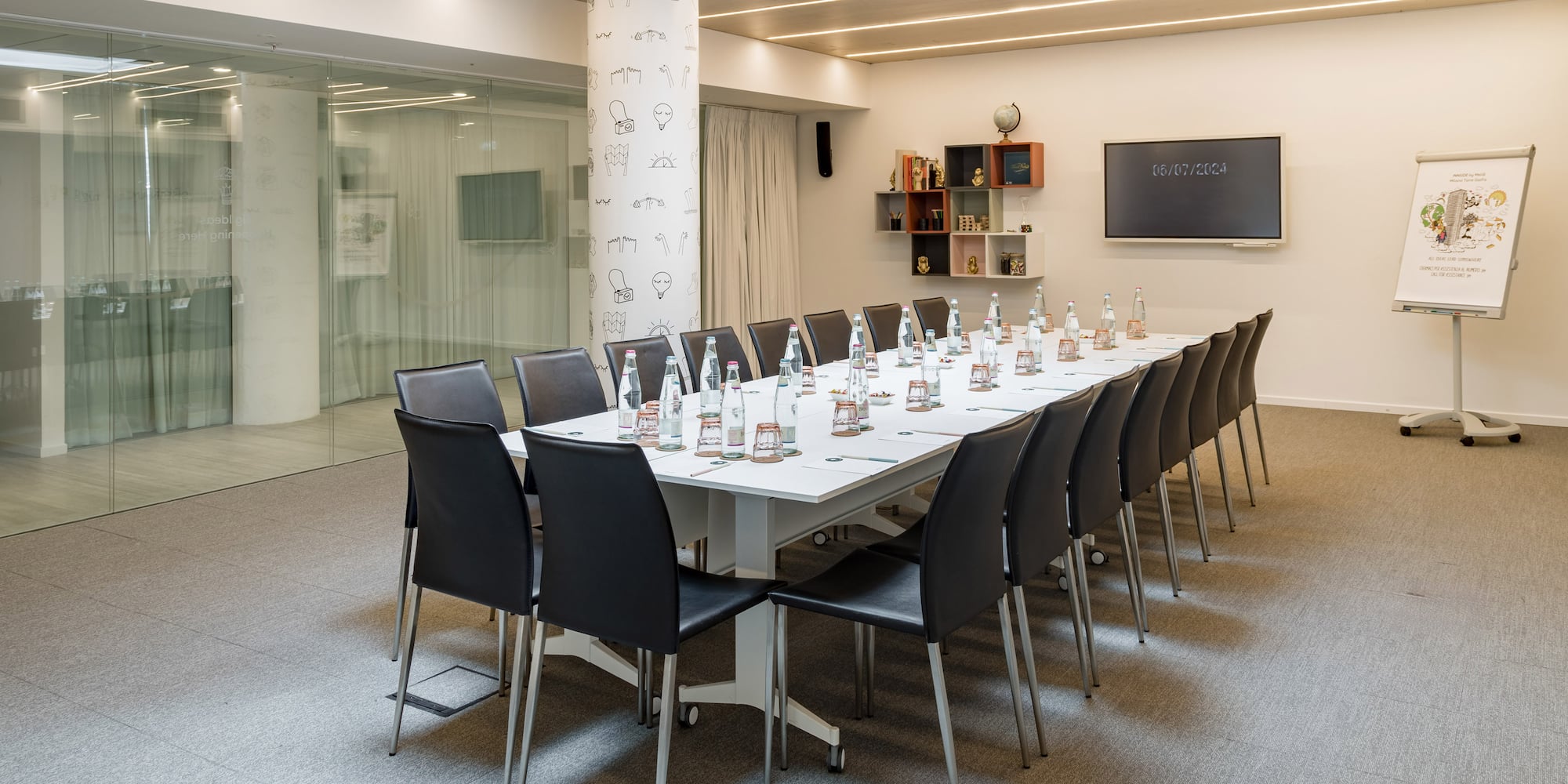 a conference room with a table with chairs and bottles of water