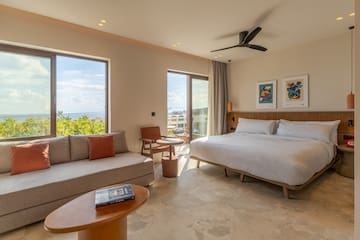 a room with a bed and couches