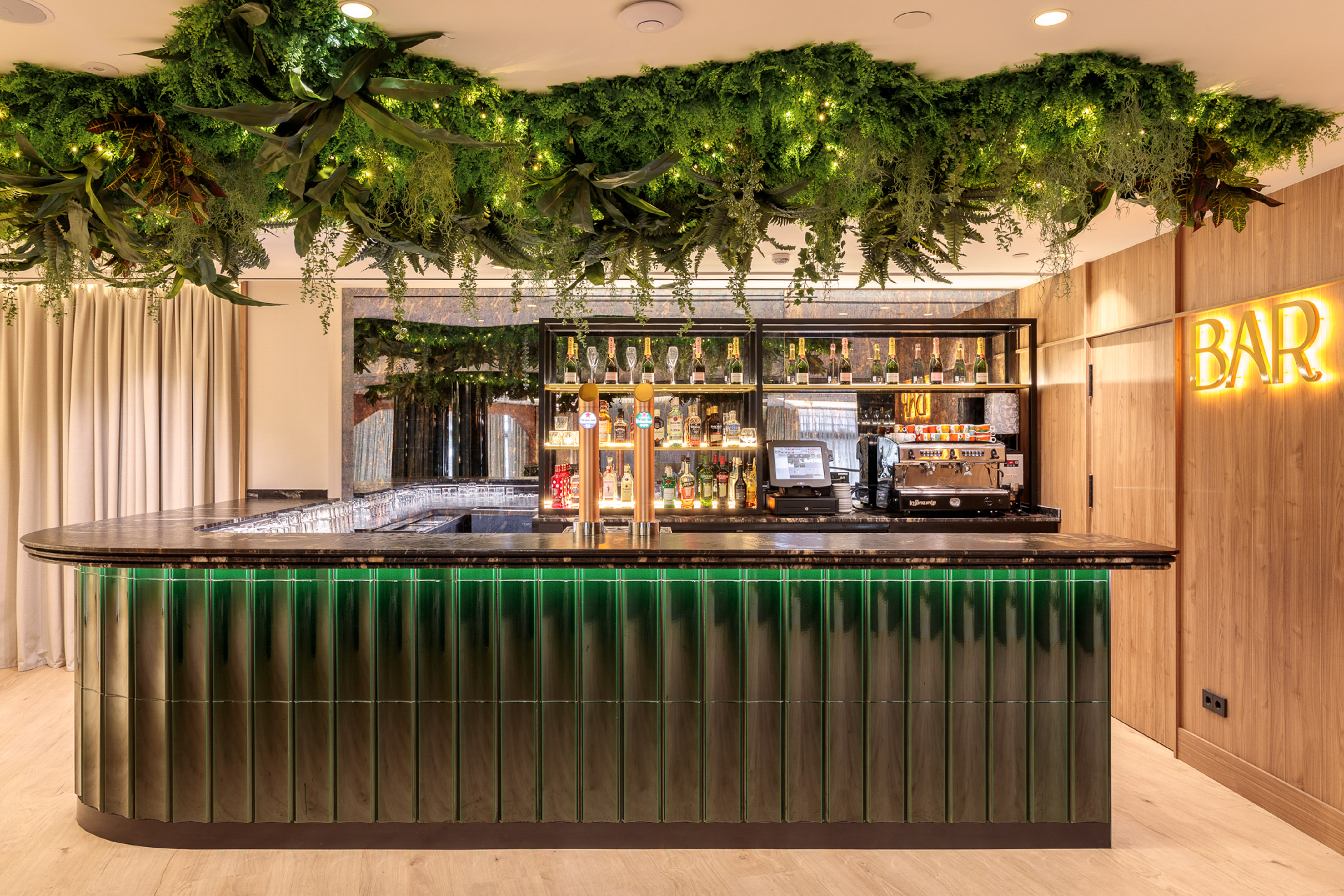 Illuminated green bar with lush ceiling plants and glowing BAR sign. - Hotel Murcia Rincón de Pepe Affiliated by Meliá, Murcia