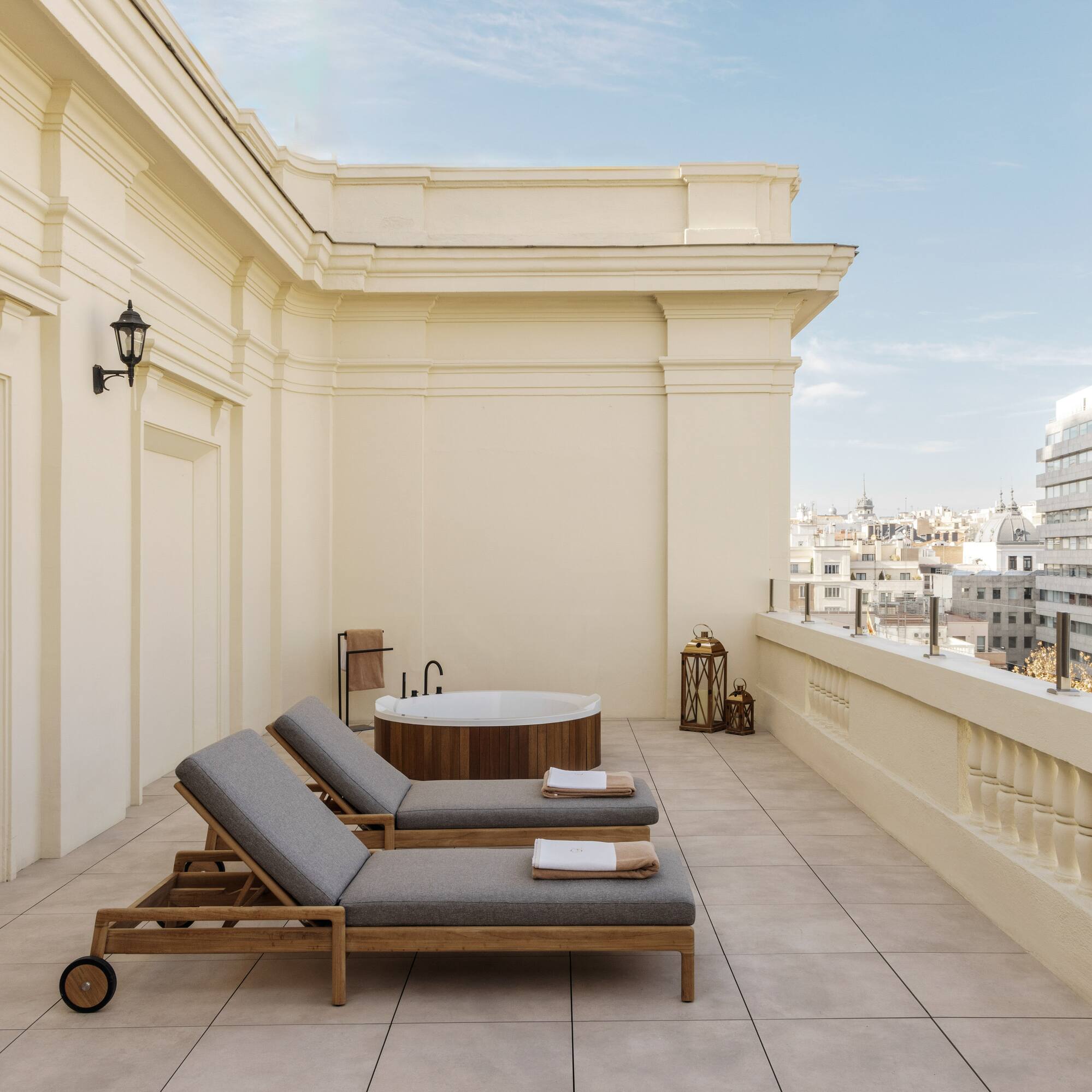 a deck with chairs and a hot tub