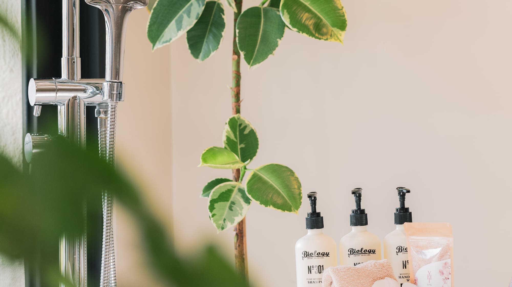 a bathroom counter with a shower head and a sink and a shower head