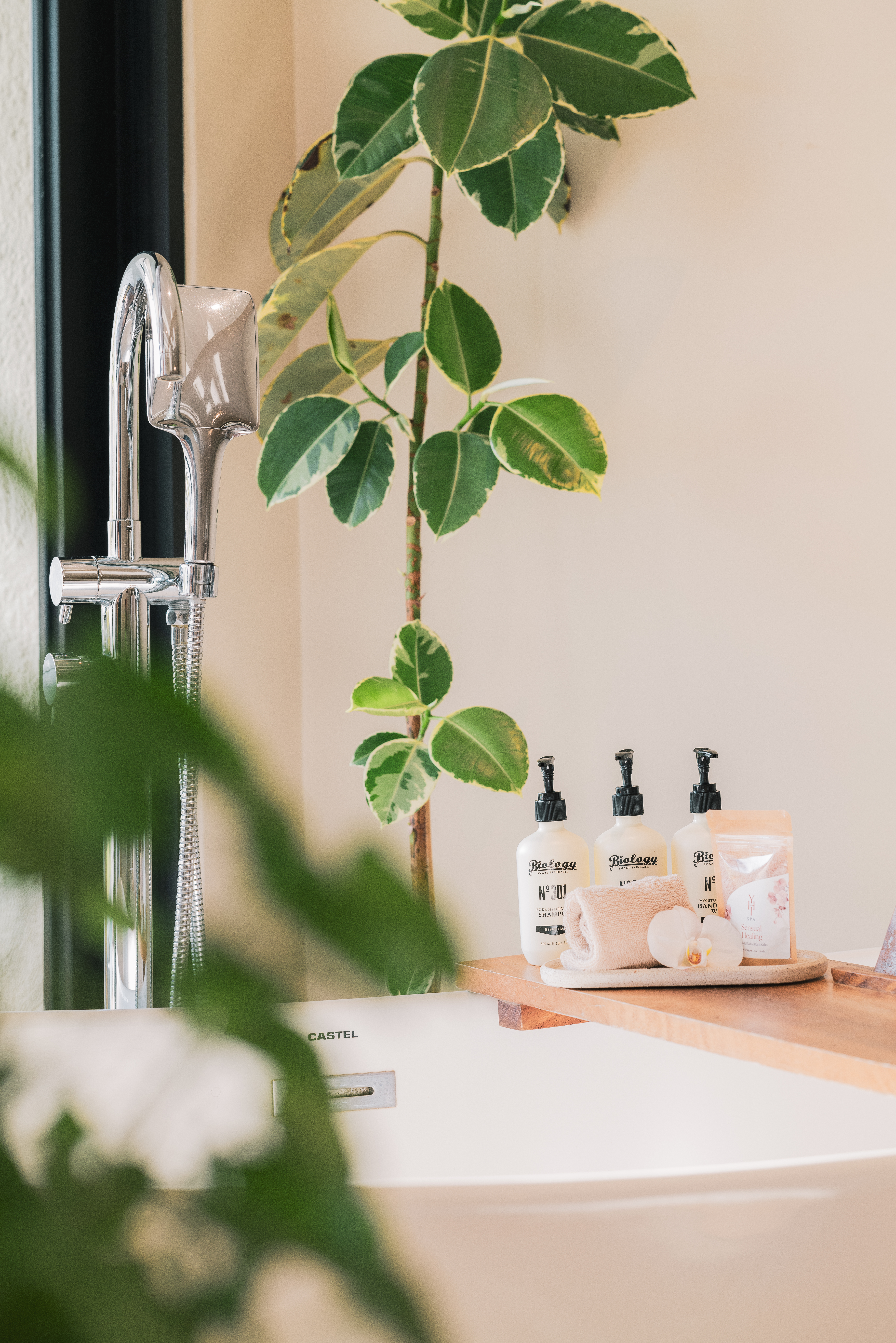 a bathroom counter with a shower head and a sink and a shower head