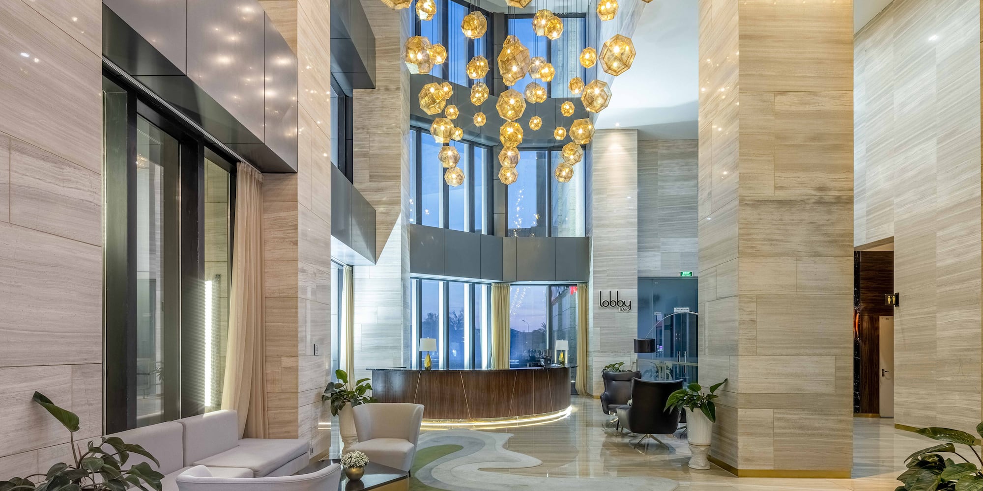 a lobby with a large chandelier and a reception area