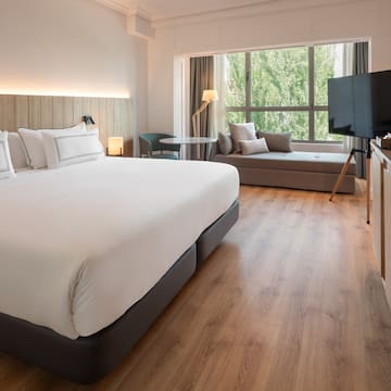 a room with a bed and a television