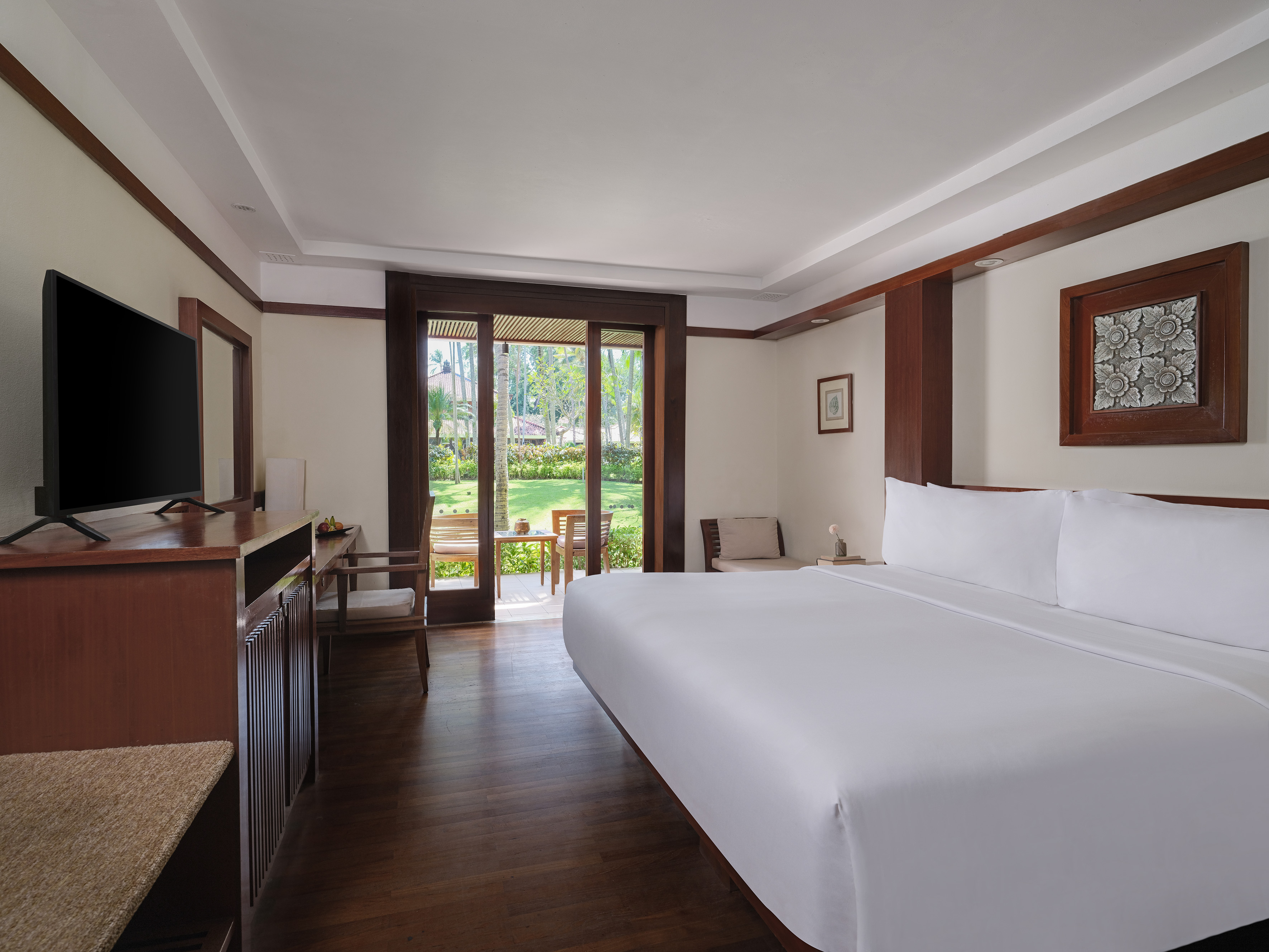 a room with a bed and a television