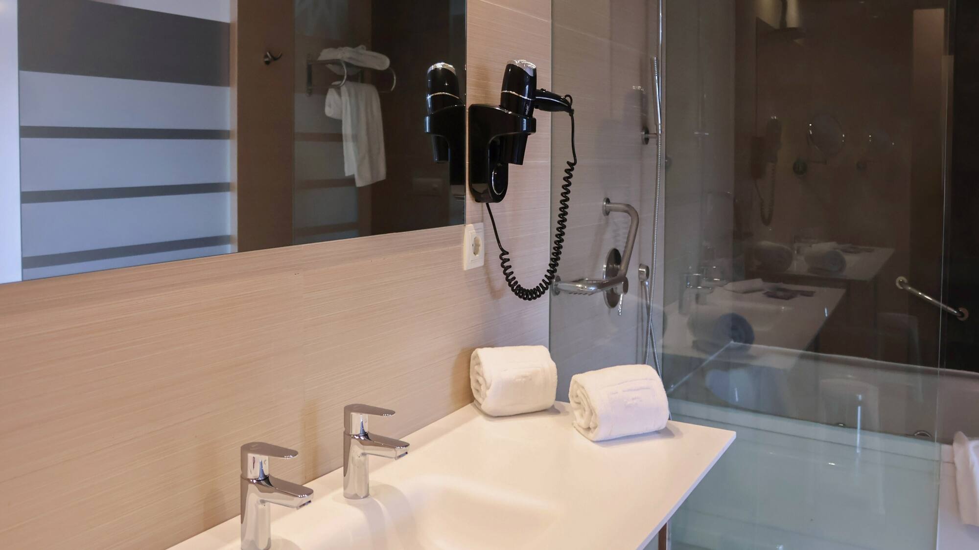 a bathroom with a shower and a sink