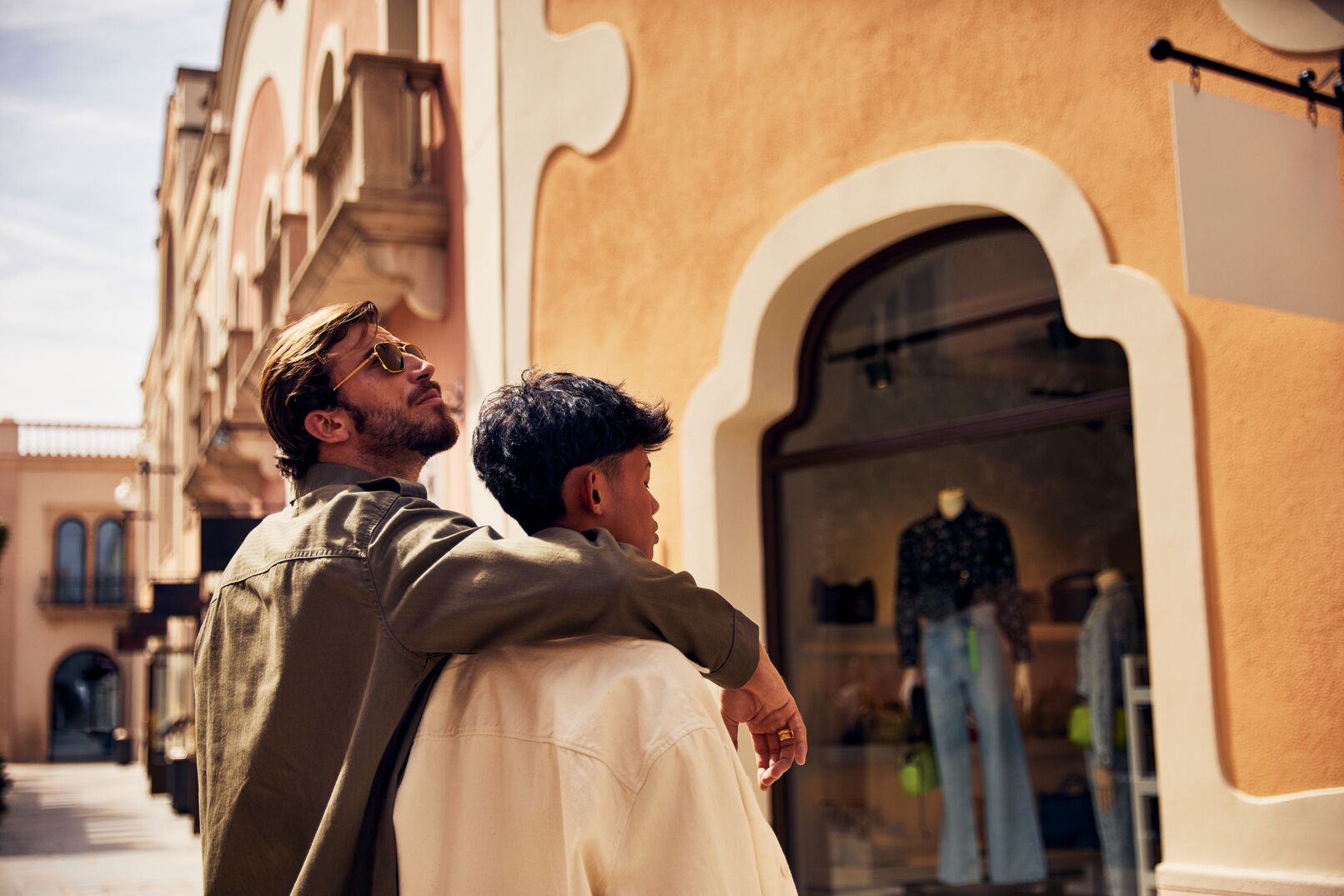 a man and boy looking at a store
