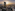 Melia Vinpearl hotel skyscraper at sunset overlooking a city and river.