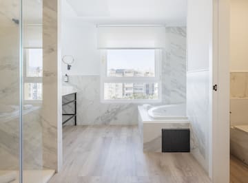a bathroom with marble walls and a tub