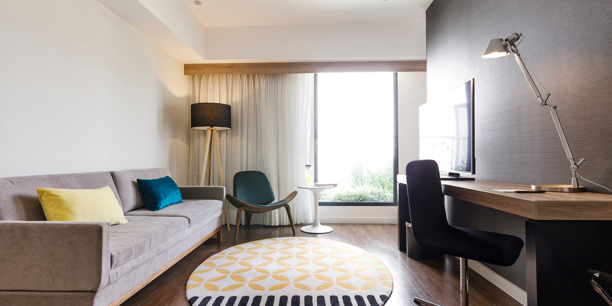 a room with a couch and a round rug