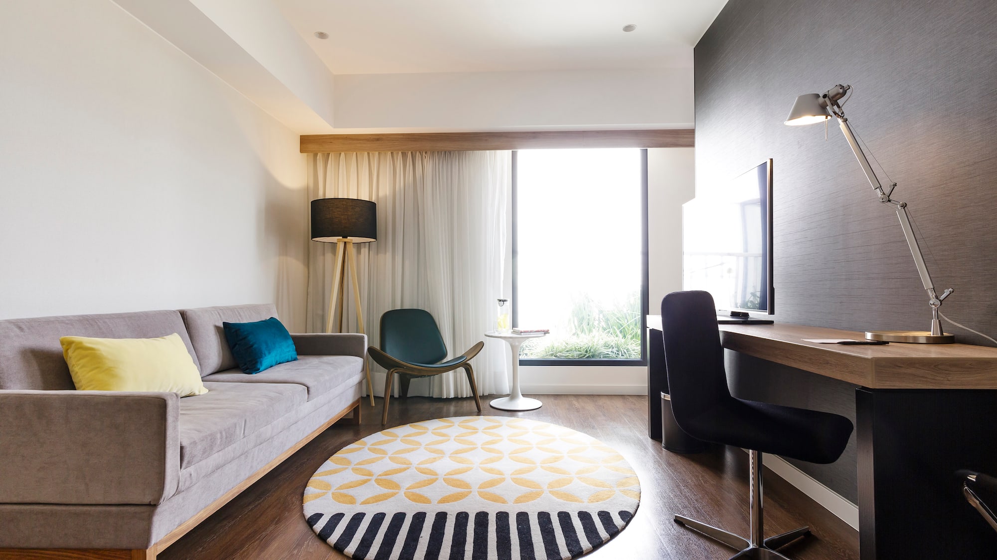 a room with a couch and a round rug