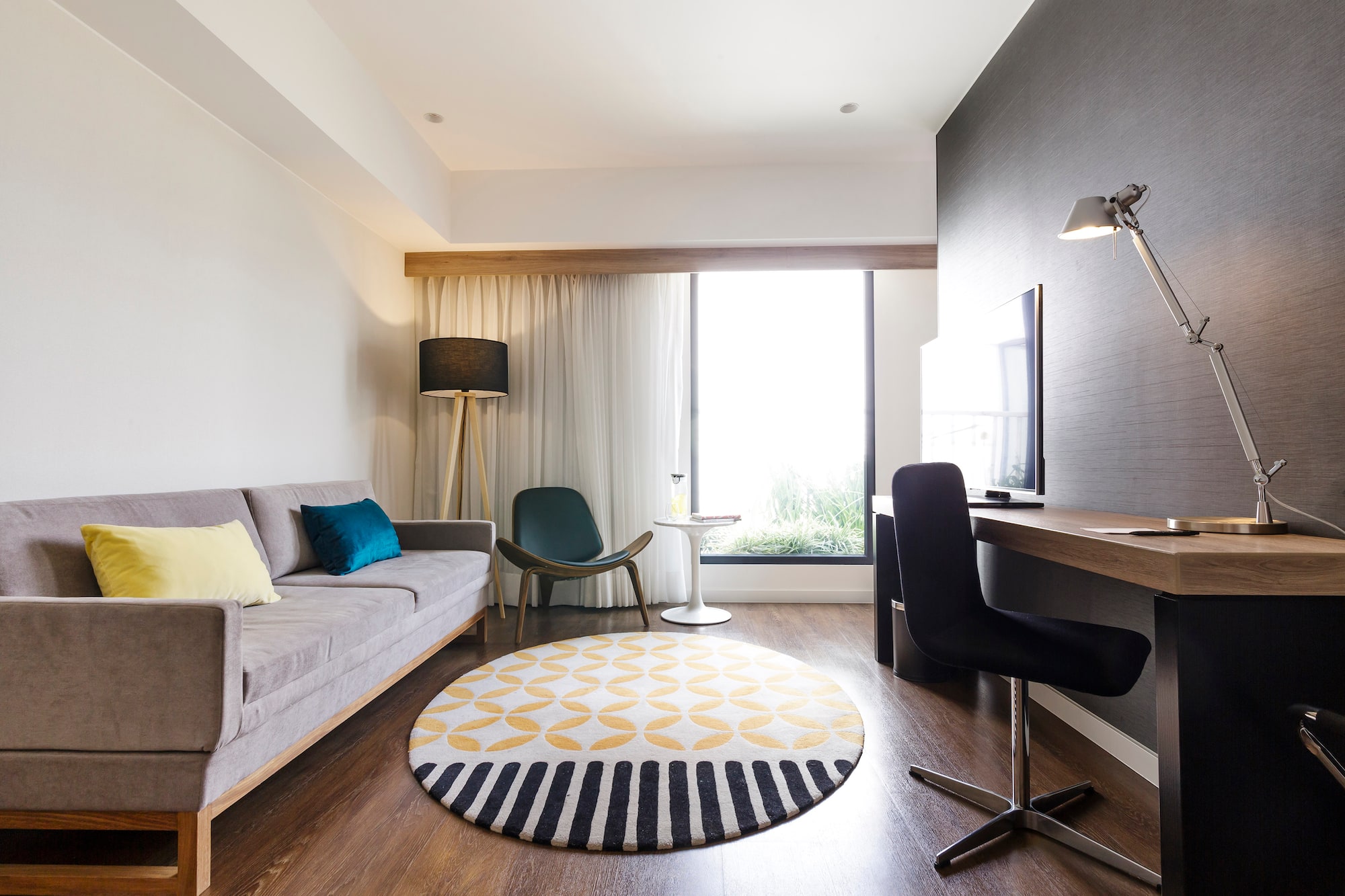 a room with a couch and a round rug