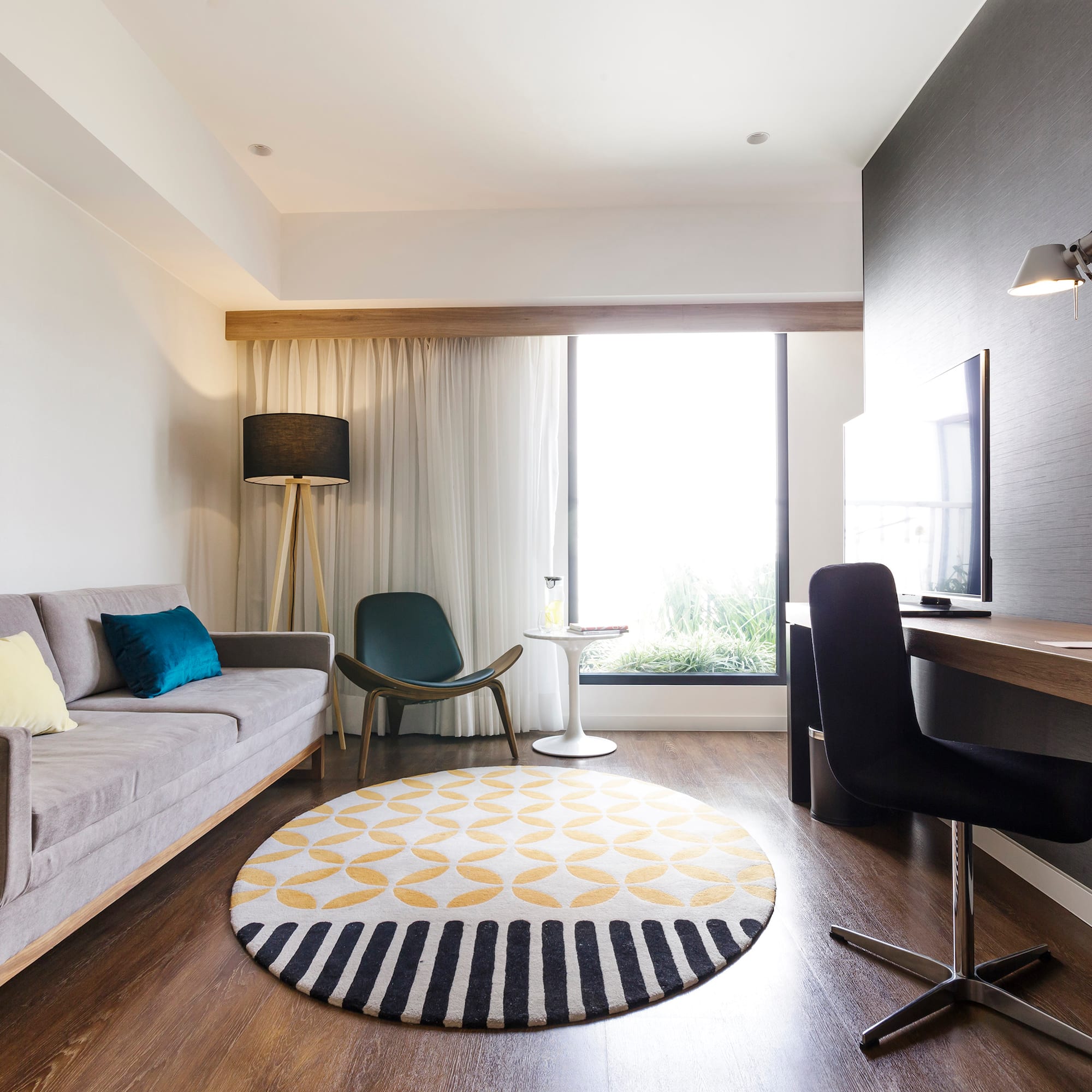 a room with a couch and a round rug