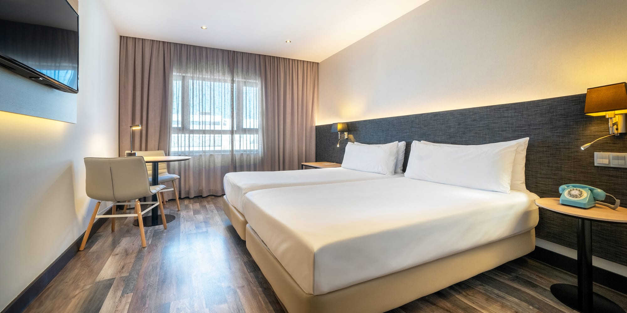 a room with two beds and a table