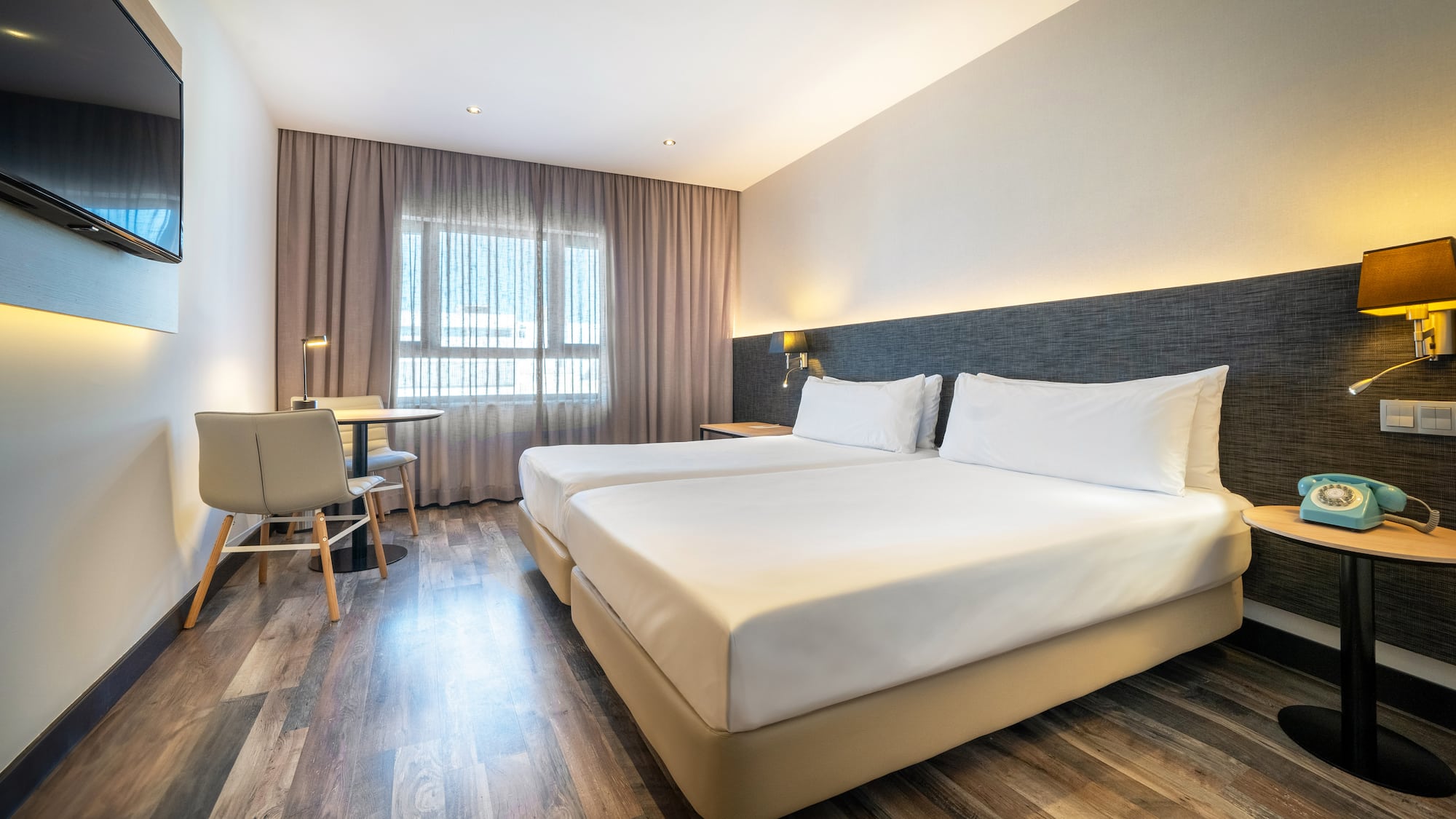 a room with two beds and a table