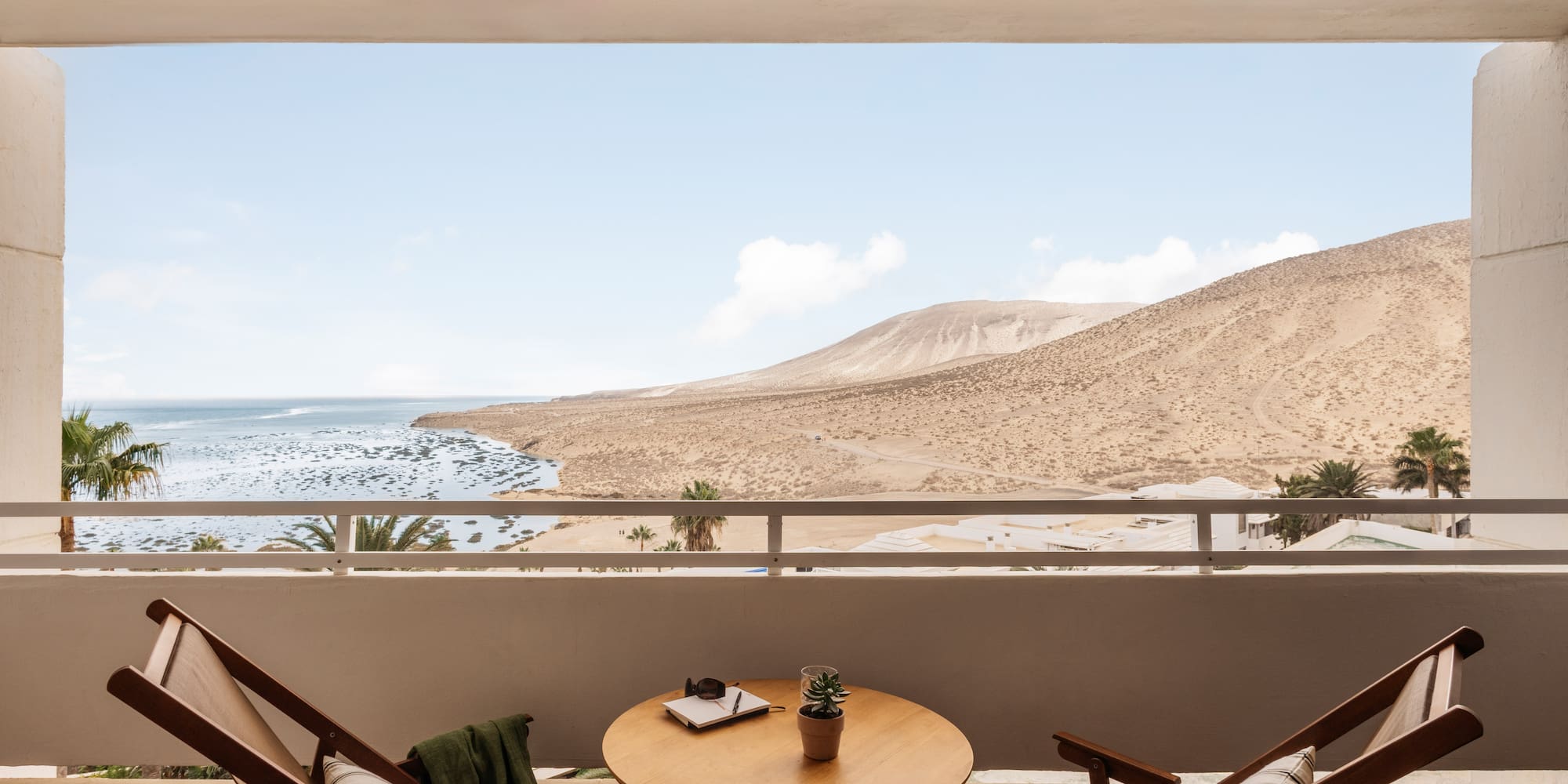 a table and chairs outside a window