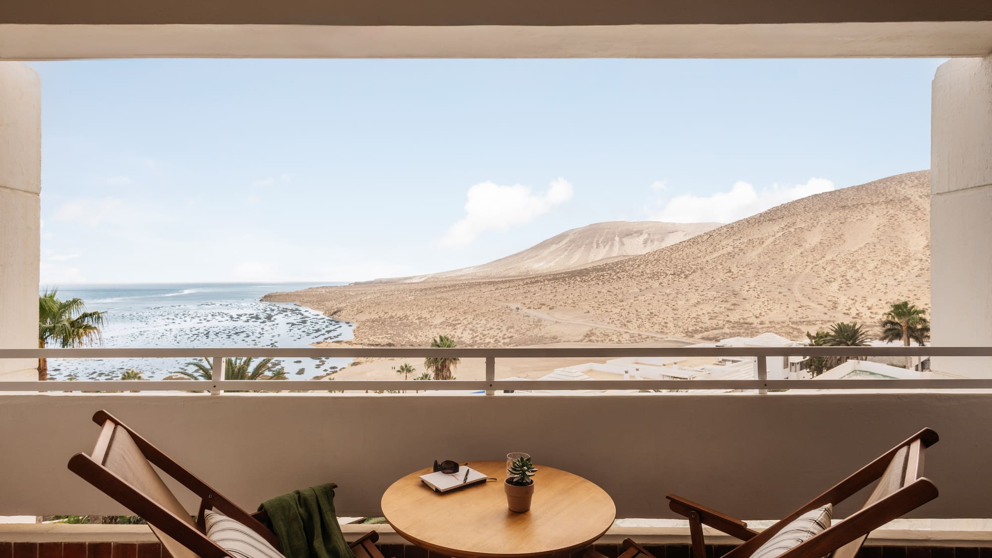 a table and chairs outside a window