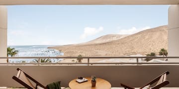 a table and chairs outside a window