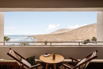 a table and chairs outside a window