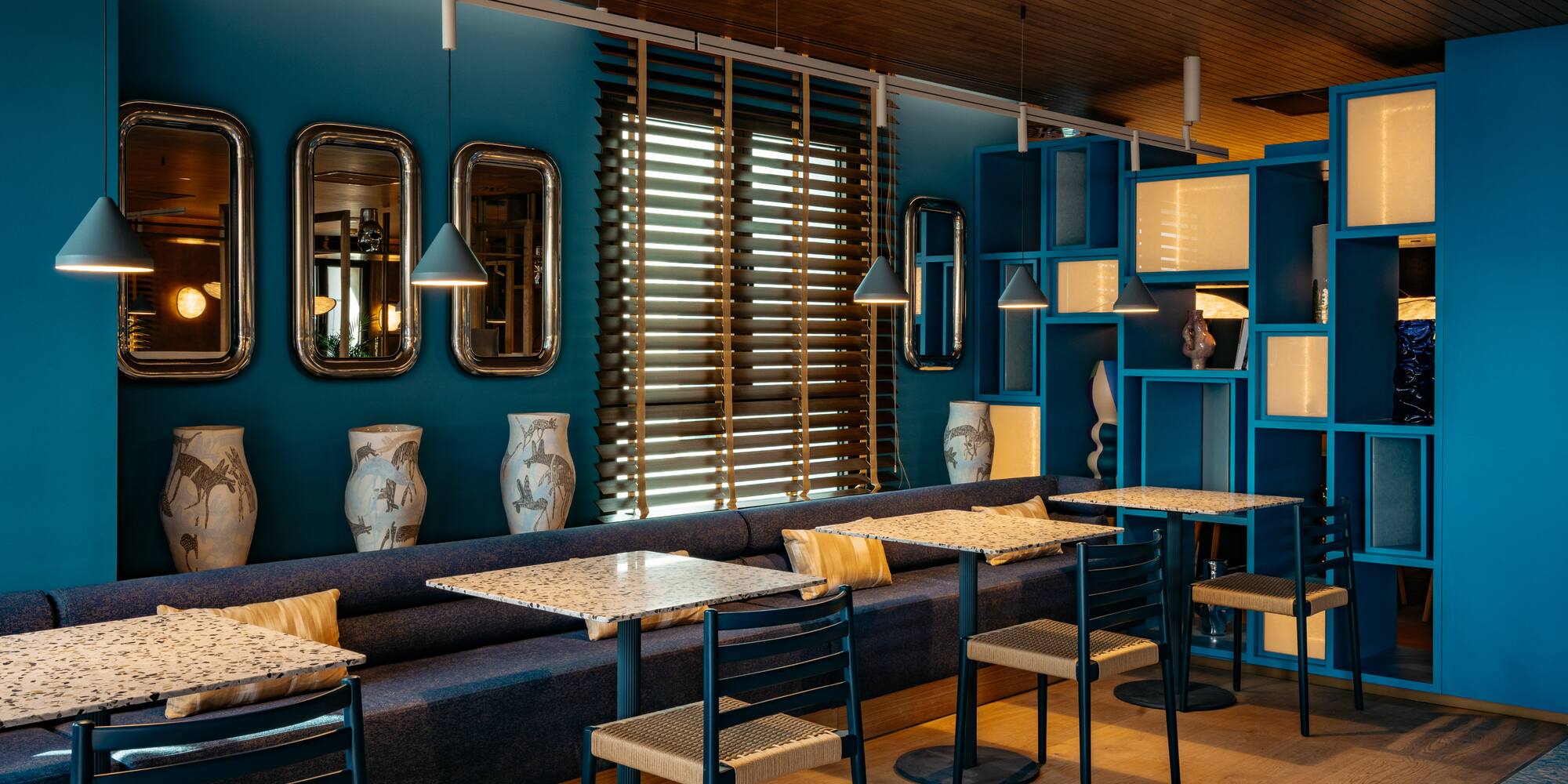 a room with blue walls and tables and chairs