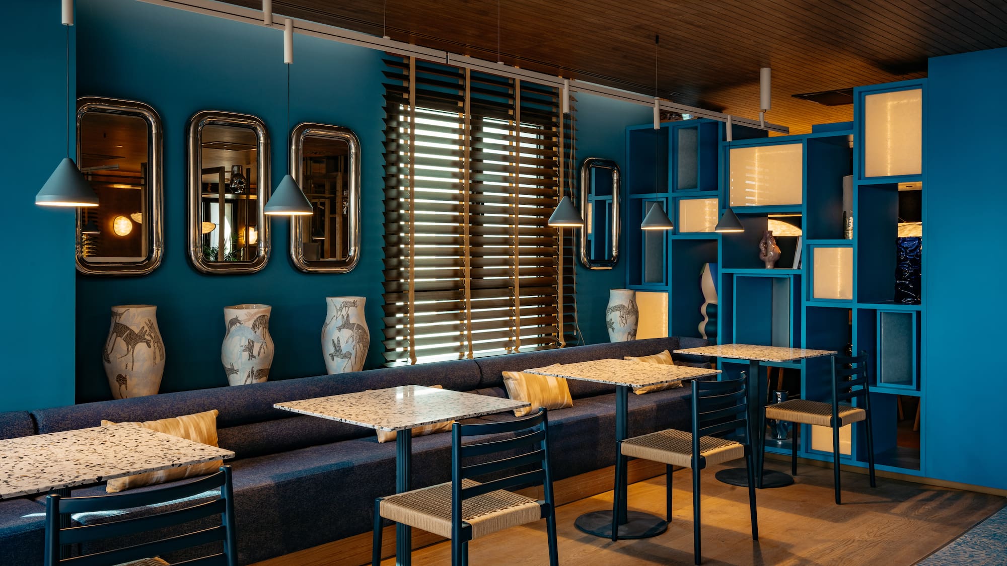 a room with blue walls and tables and chairs