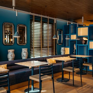 a room with blue walls and tables and chairs