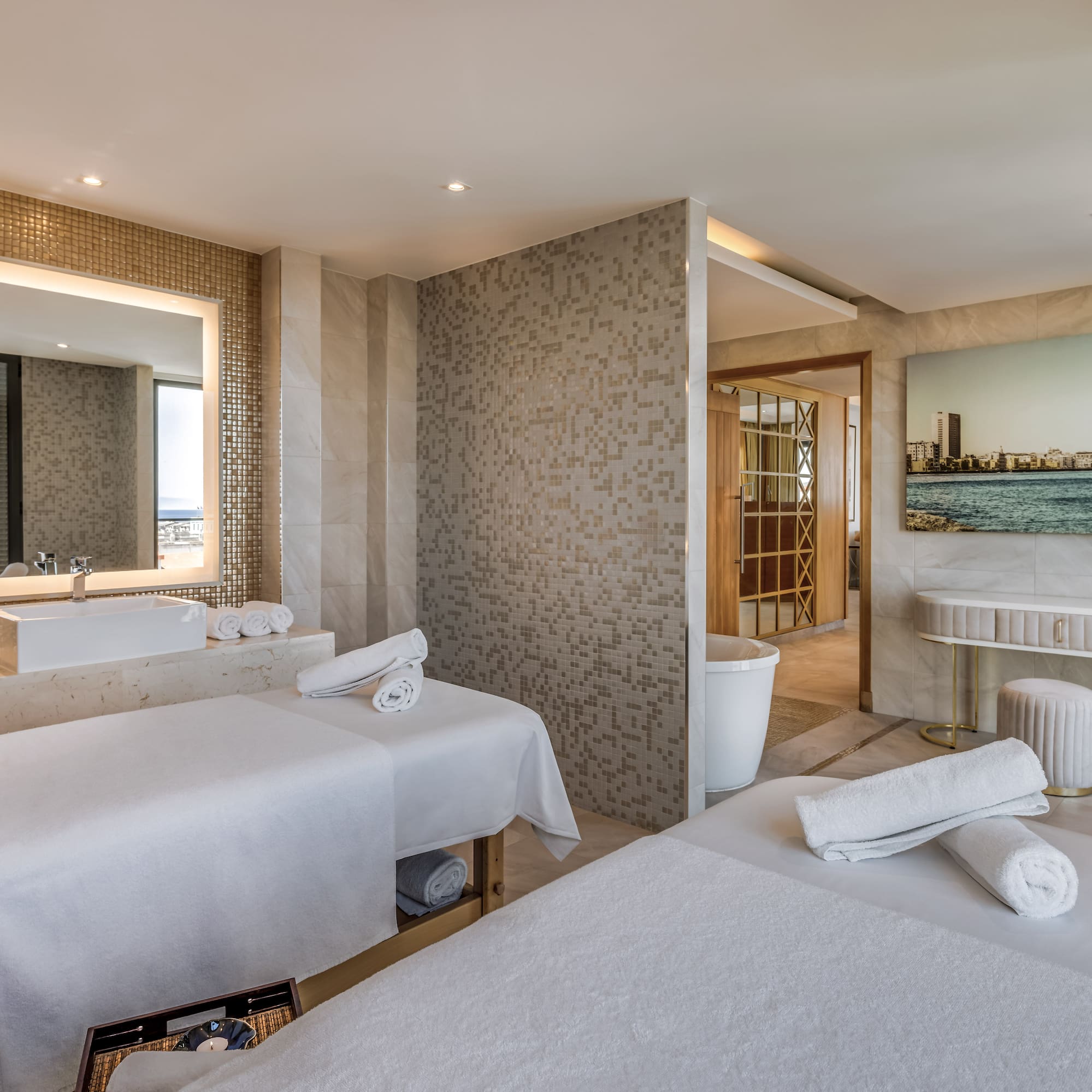 a room with beds and a sink