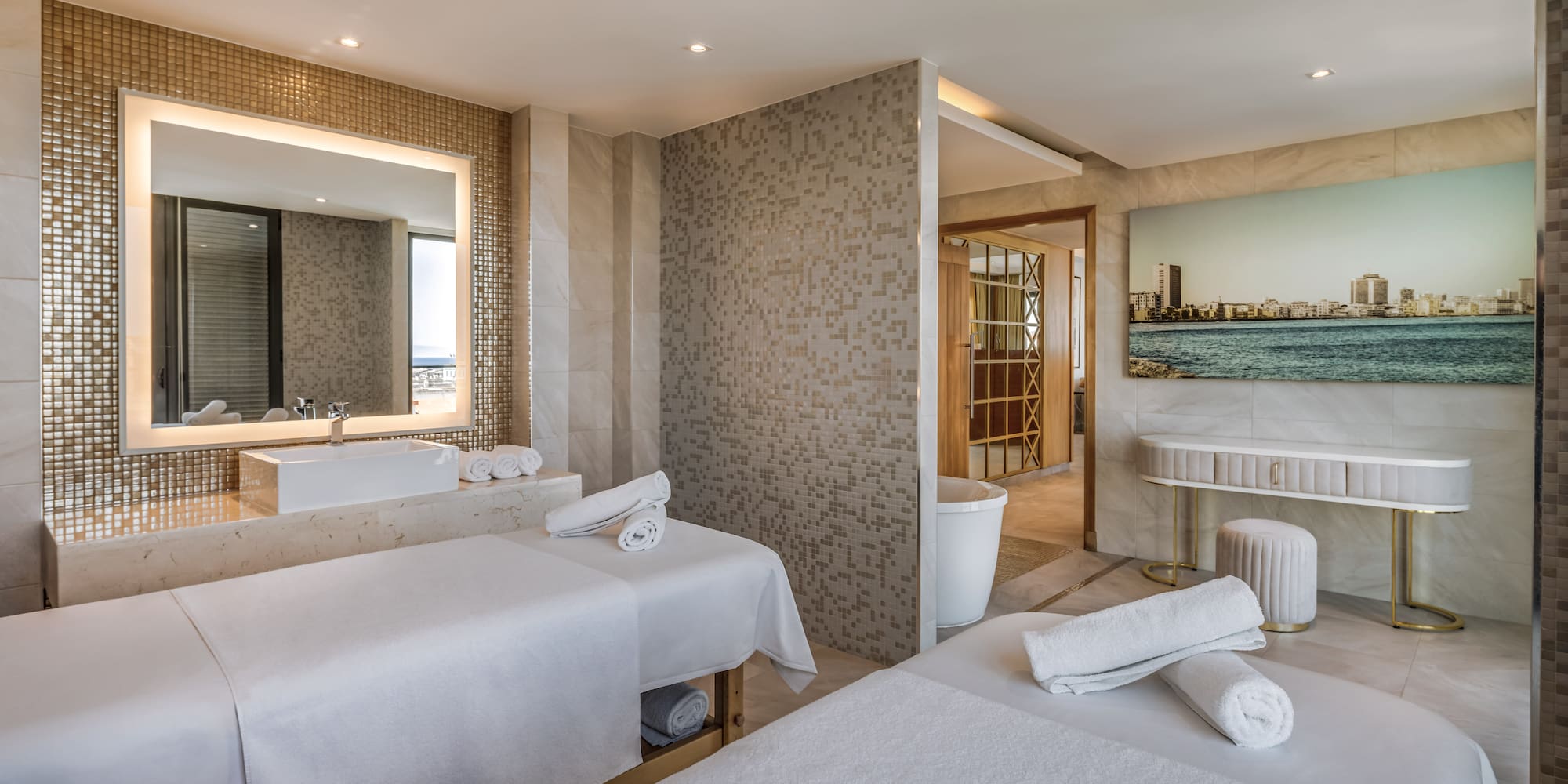 a room with beds and a sink