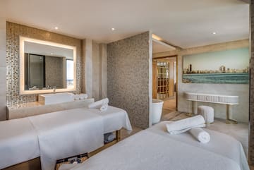 a room with beds and a sink