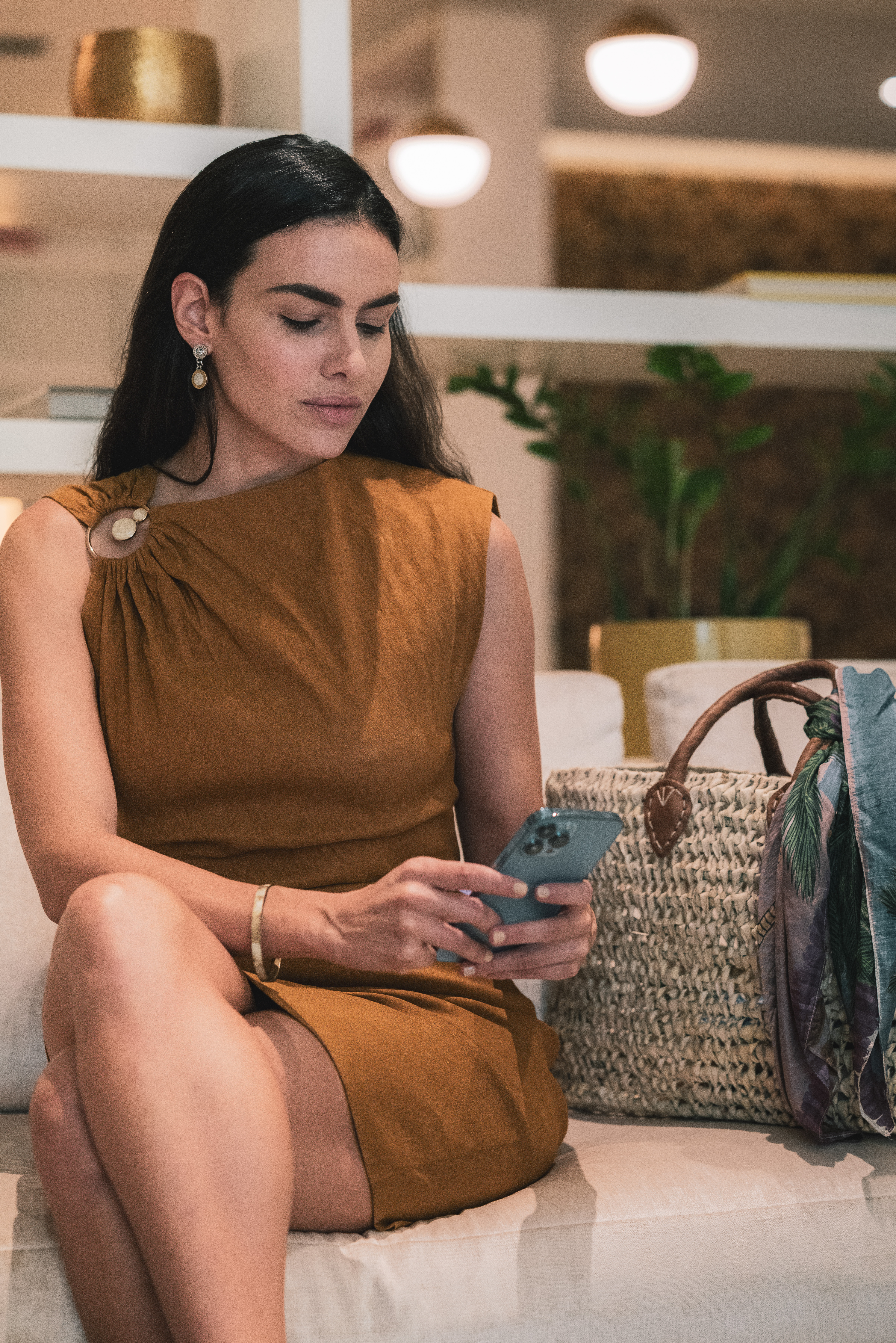 a woman sitting on a couch looking at her phone